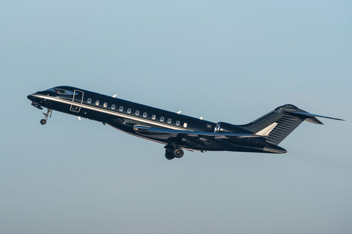 Black modern private business jet taking off